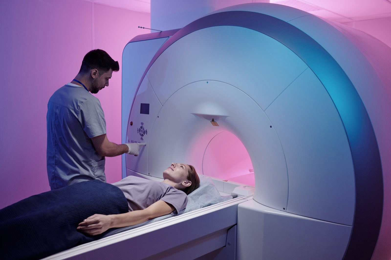 Technician preparing a patient for an MRI scan