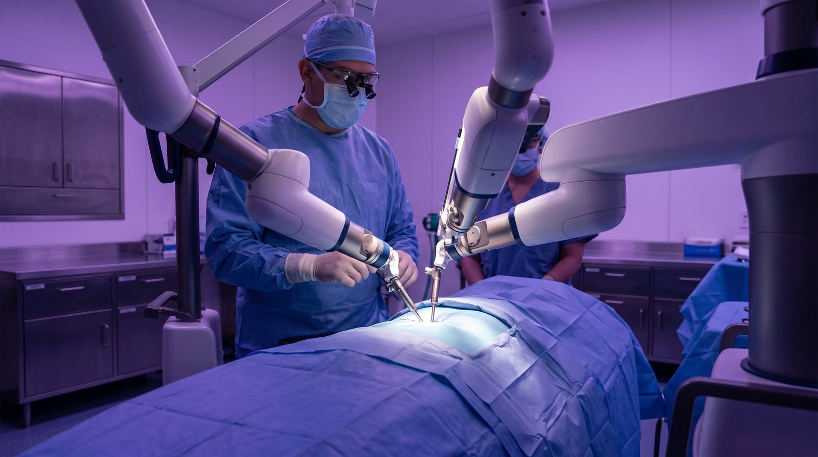 Surgeon and assistant working with a robotic system in the operating room